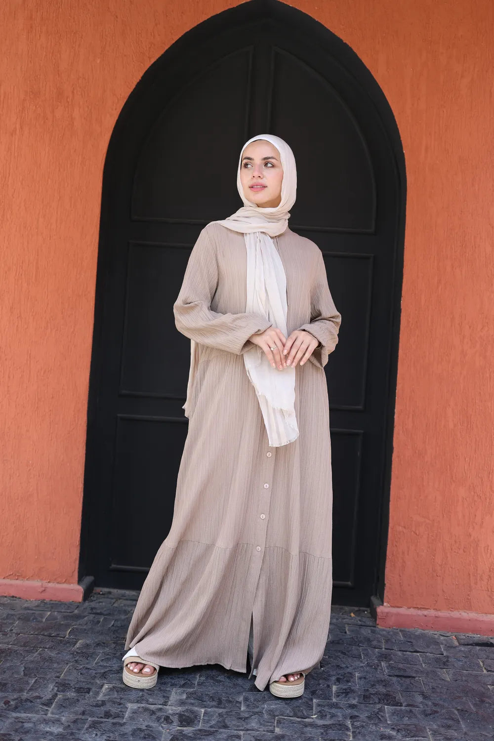 Beige modest maxi dress with long sleeves and flowing silhouette, full-length front view