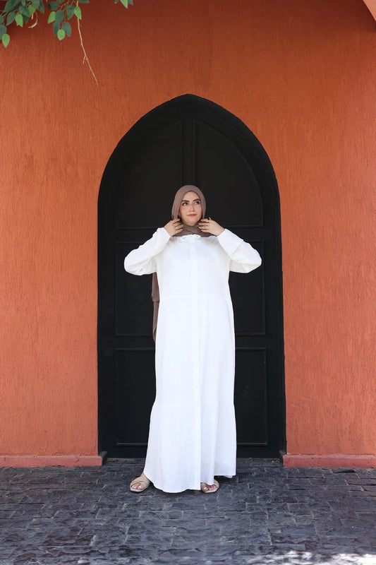 White modest maxi dress with long sleeves and closed neckline, front view styled for everyday modest wear