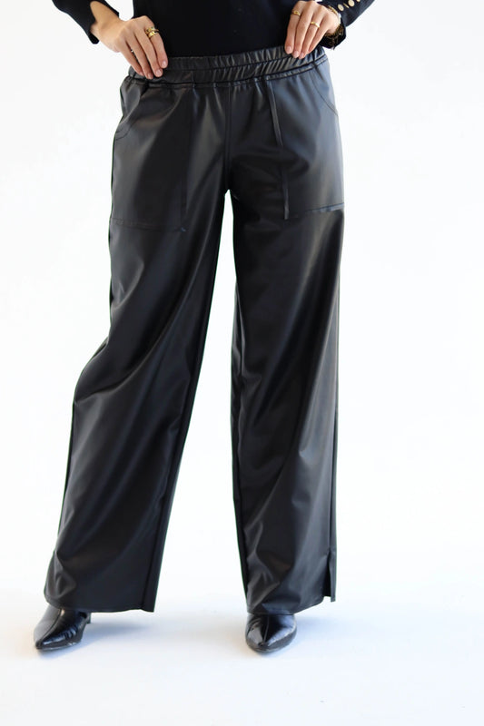 Black wide-leg pants worn by a person on a white background