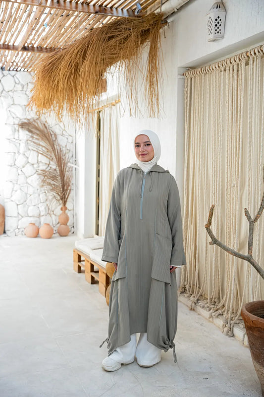 Woman wearing a modest casual dress with relaxed fit and long sleeves, styled with hijab