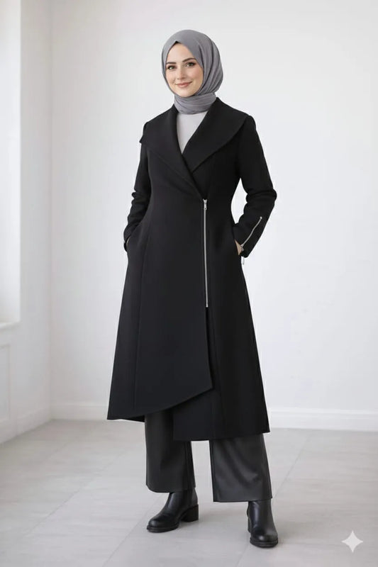 Woman wearing a black coat with a gray hijab against a white background