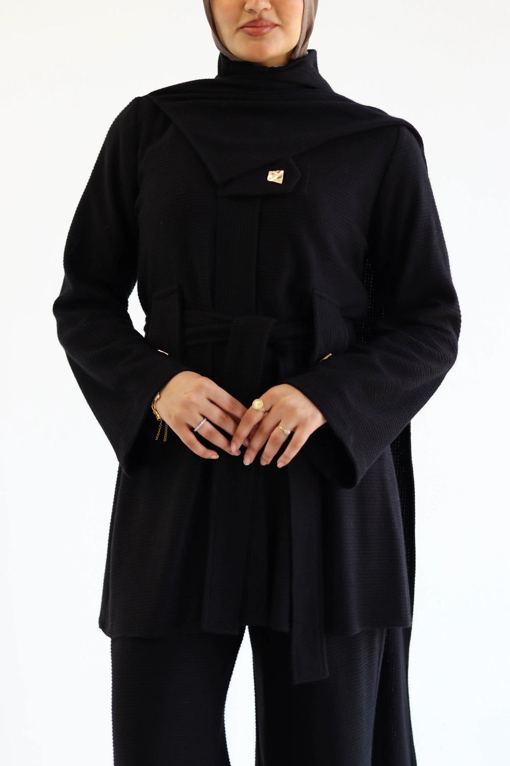 Woman wearing a black Knit Set with a hijab on a white background