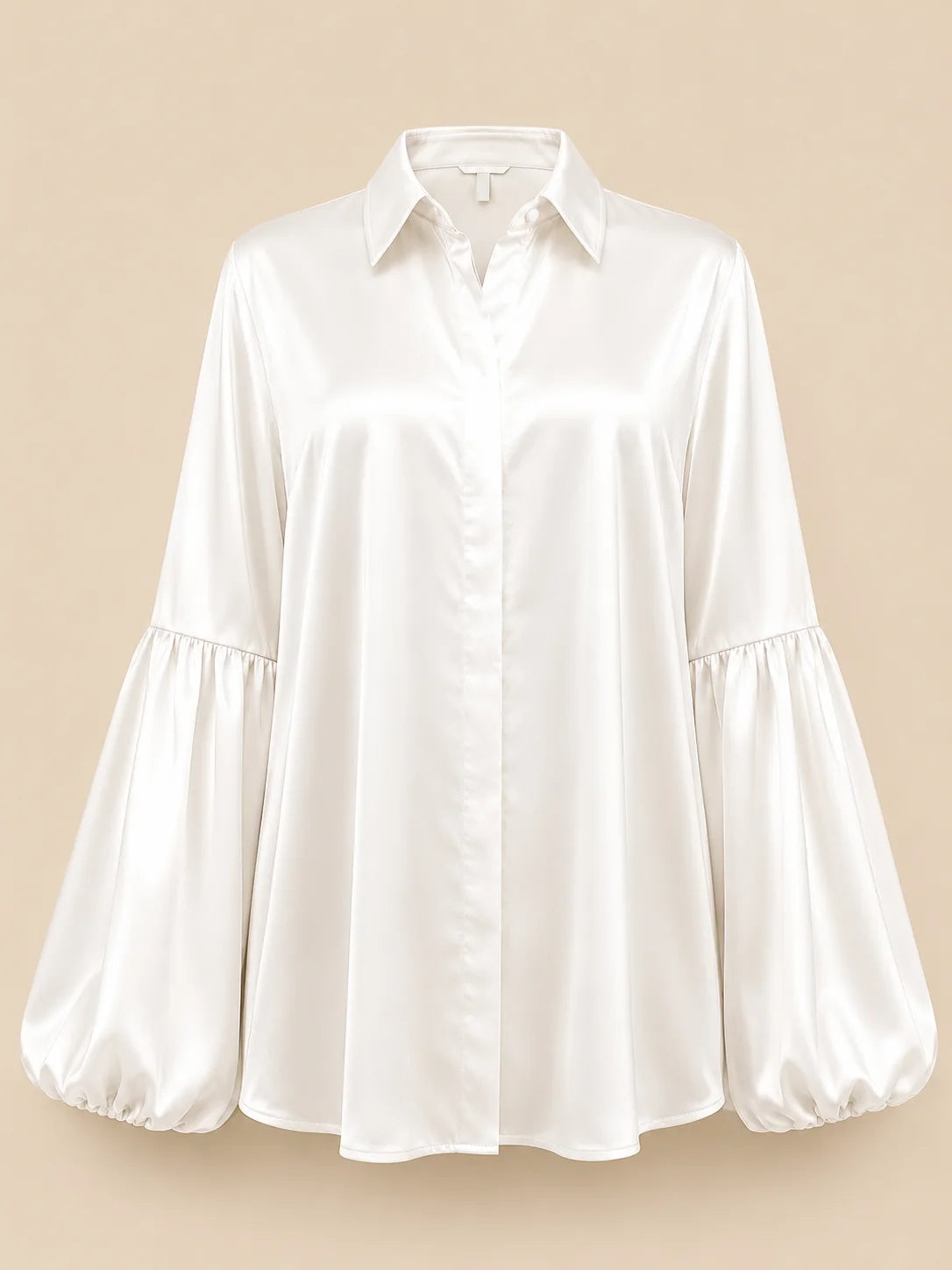 A white long-sleeve satin blouse with a pointed collar, button front, and gathered balloon sleeves, shown against a solid beige background.