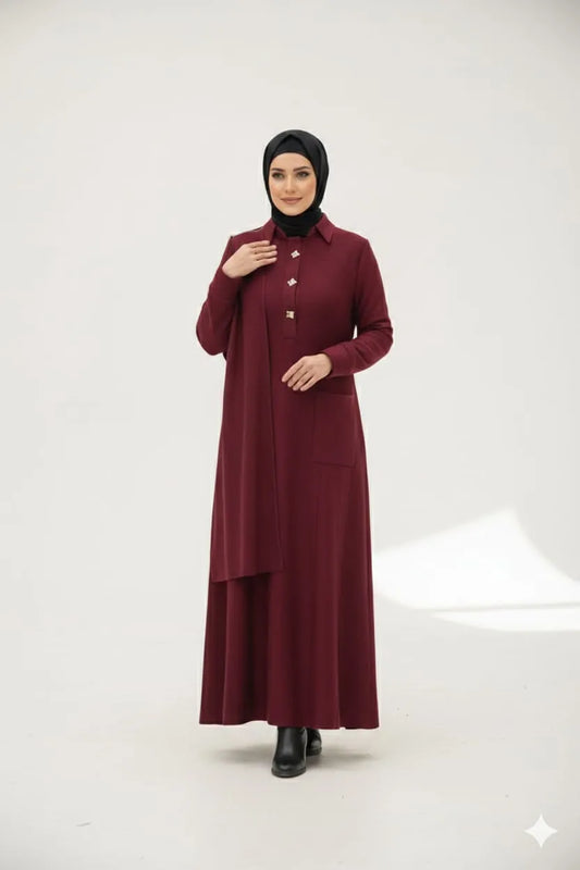 Woman in a hijab wearing a burgundy dress with a black hijab on a white background