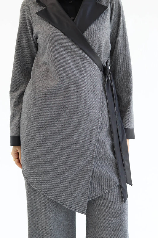 Gray wrap cardigan with black trim on a white background