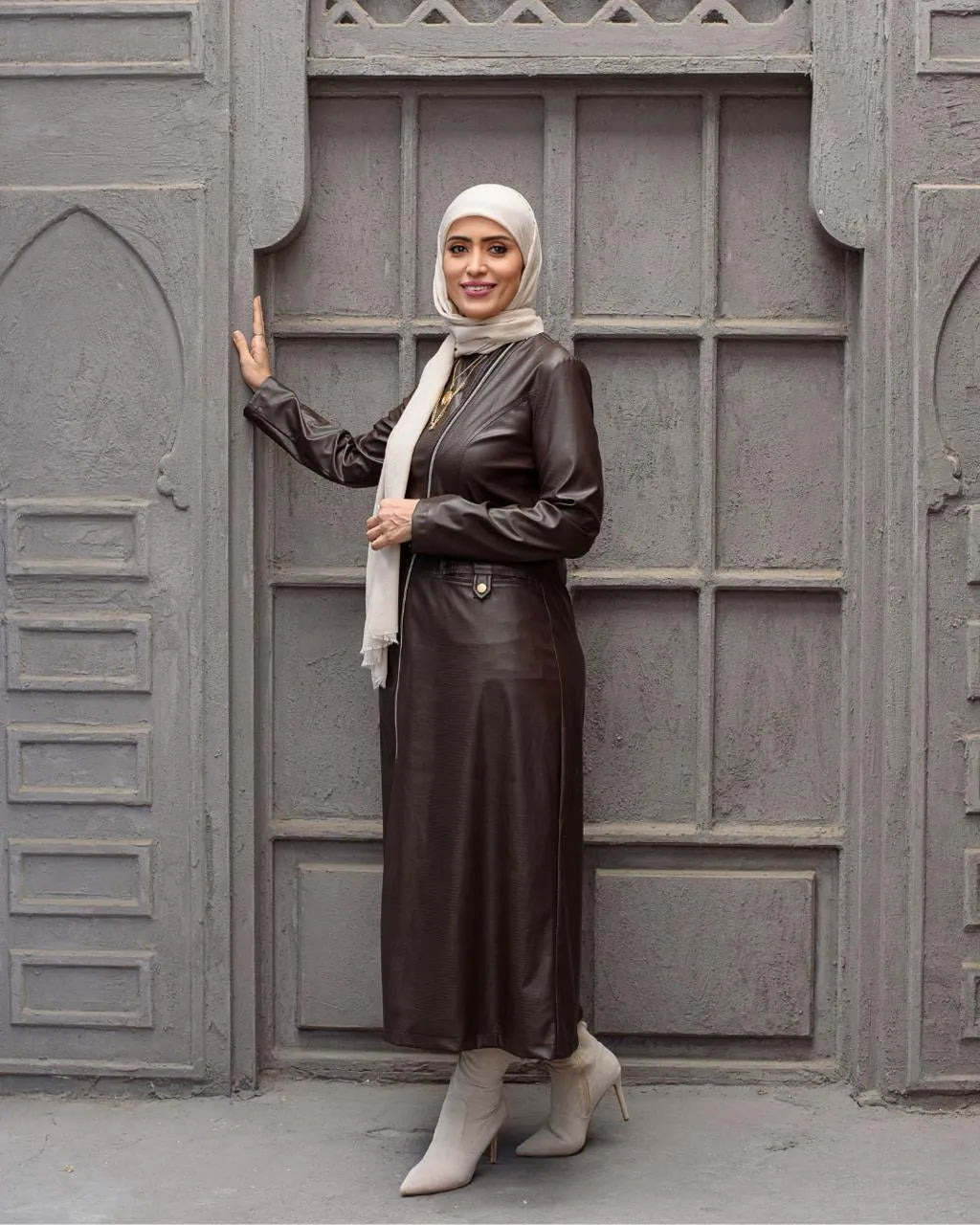 Brown crocodile-effect coat dress — full-length front view with hijab styling