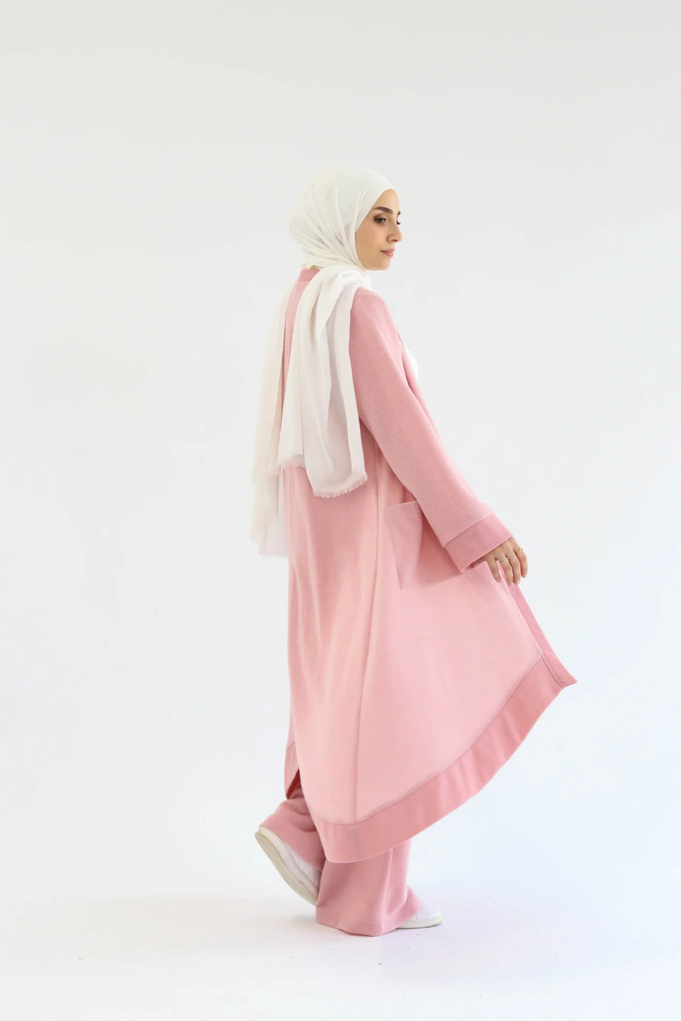 Pink knitted cardigan set side view highlighting open-front cardigan and wide-leg pants.