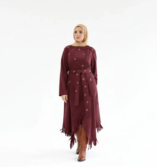 Woman wearing a burgundy dress with a hijab on a white background