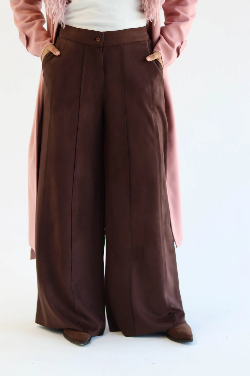 Brown wide-leg pants worn by a person on a white background