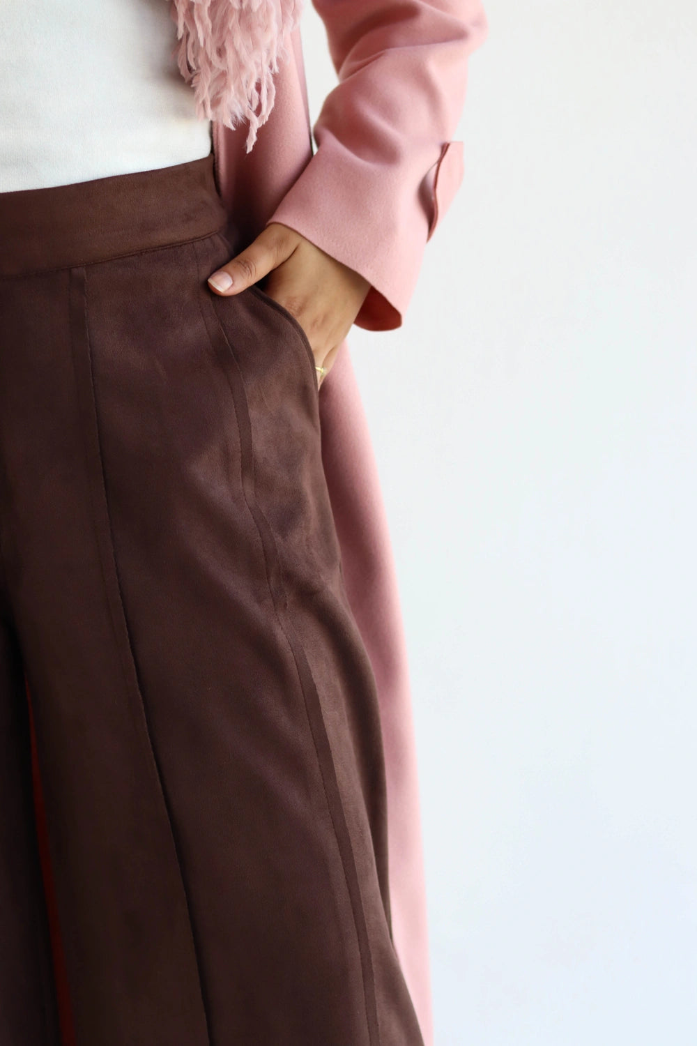 Brown pants with a pink jacket on a light background
