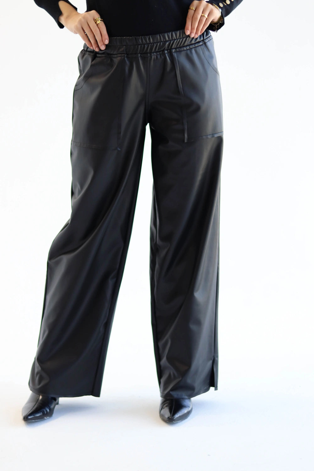 Black wide-leg pants worn by a person on a white background