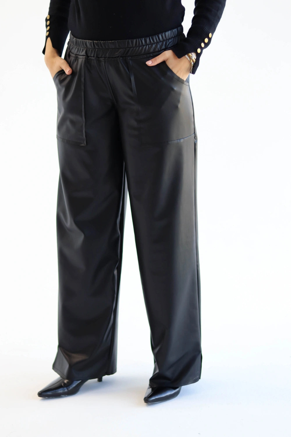 Black wide-leg pants worn by a person on a white background