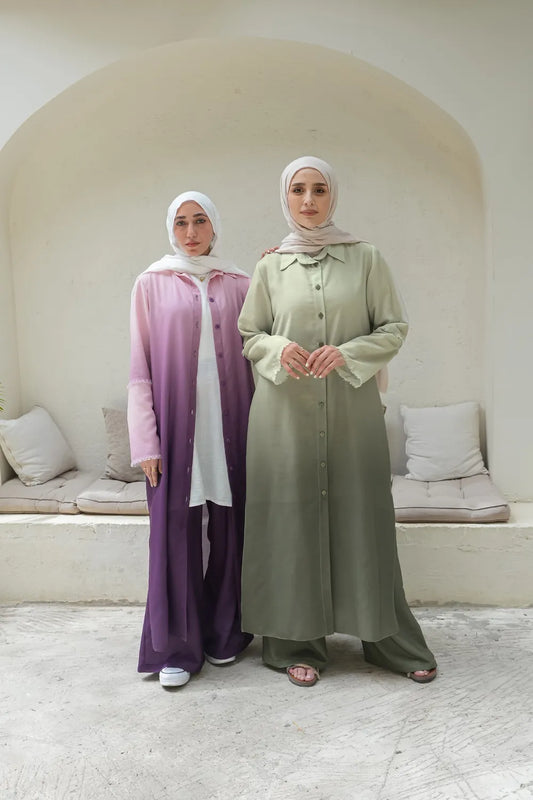 Two women wearing coordinated modest sets with long tops and matching pants in different colors