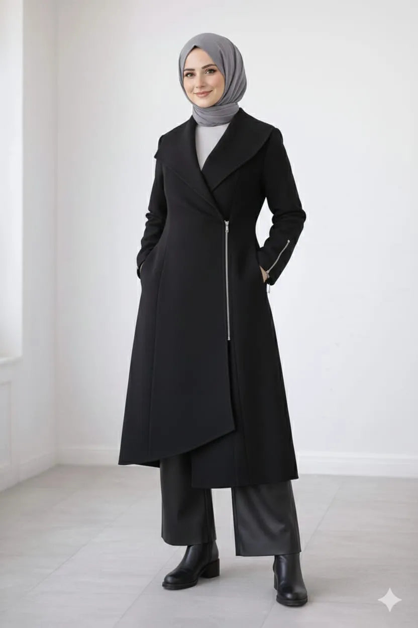 Woman wearing a black coat with a gray hijab against a white background