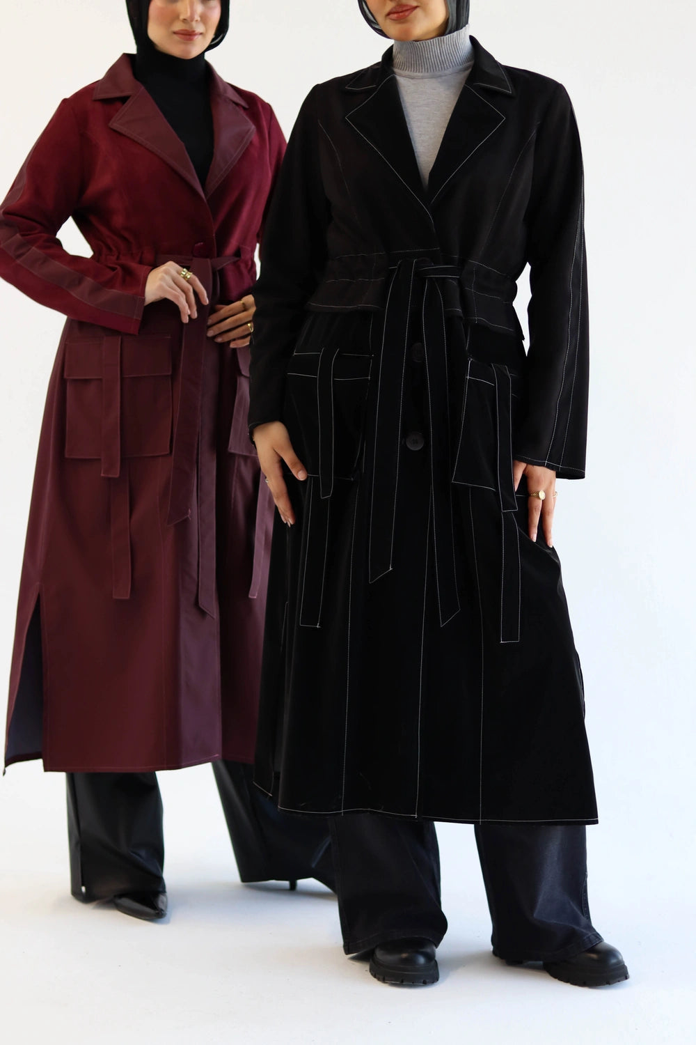 Two Women wearing Long suede trench coat with waterproof finish styled for modest winter layering, one red and one black, on a white background.