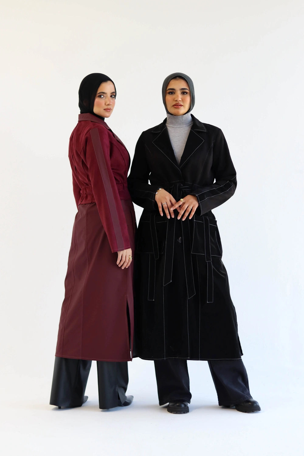Two women wearing Long suede trench coat with waterproof finish styled for modest winter layering and hijabs on a white background
