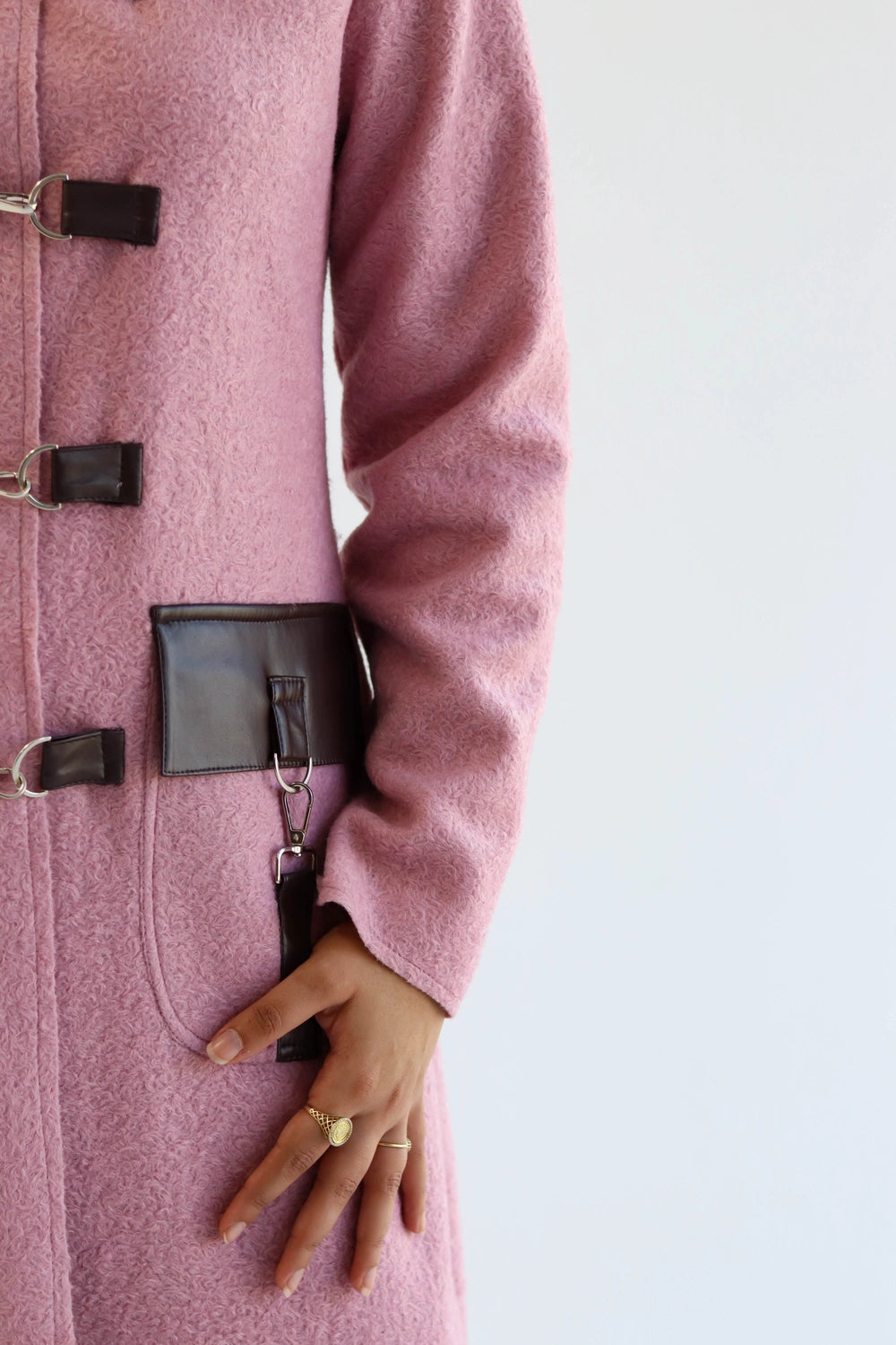 Wool jacket detail showing buckle-style fastenings