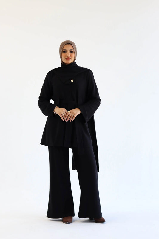 Women wearing a black Elegant knit jacket and pants modest winter set on a white background