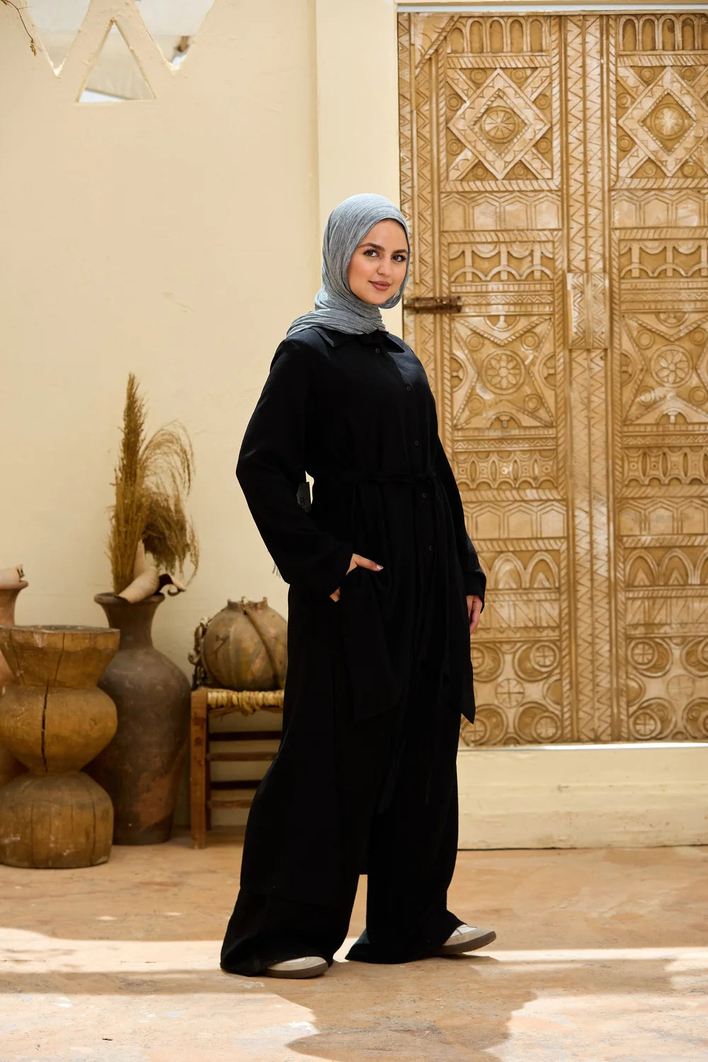 Three-quarter view of the black High-Low Triangle Hem Tunic showing its longline relaxed fit