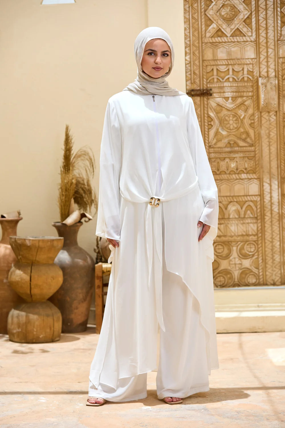 Full-length front view of the white Layered Chiffon Triangle Hem Tunic and wide-leg trousers