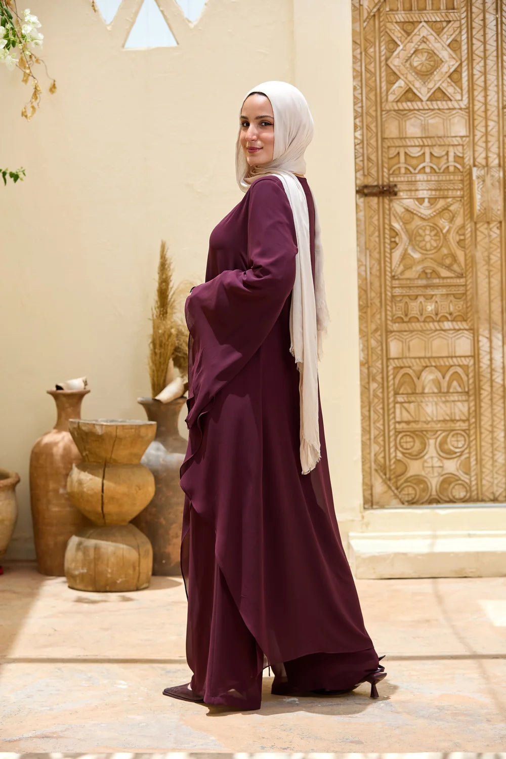 Full-length back view of the deep purple Layered Chiffon Triangle Hem Tunic with flowing front panel