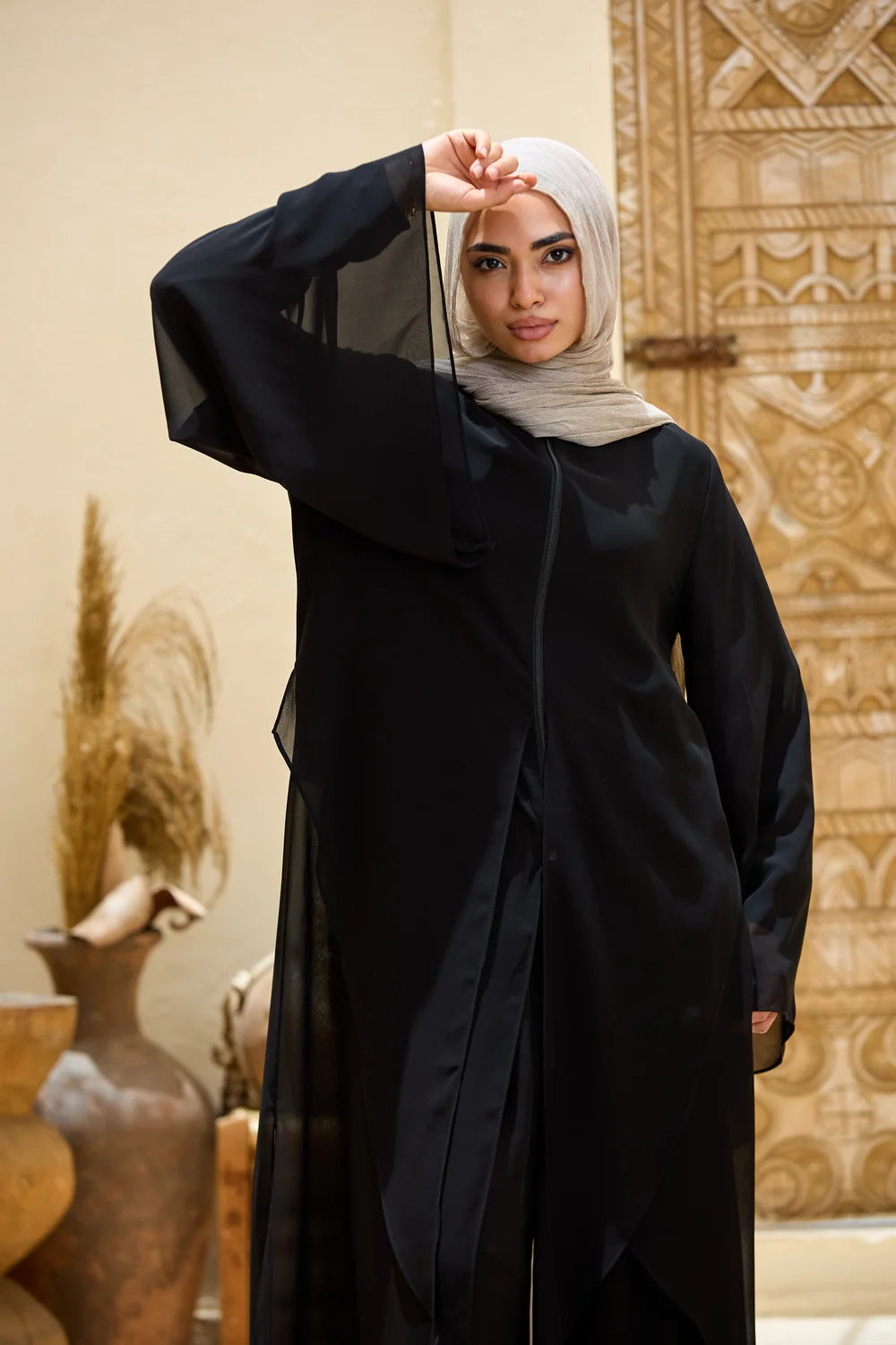 Front upper-body view of the black layered chiffon tunic with wide bell sleeves