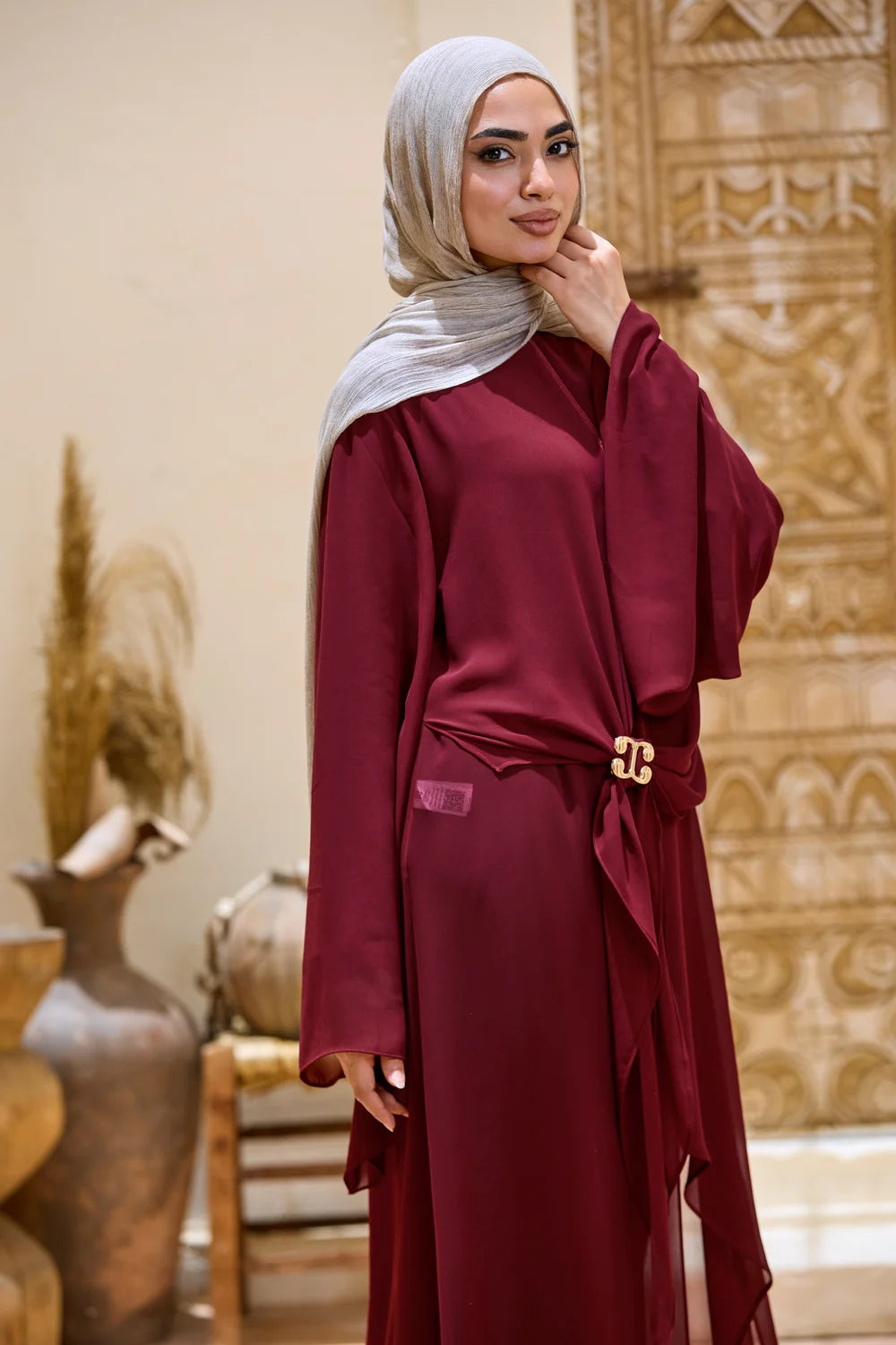Side view of the burgundy Layered Chiffon Triangle Hem Tunic with a relaxed drape