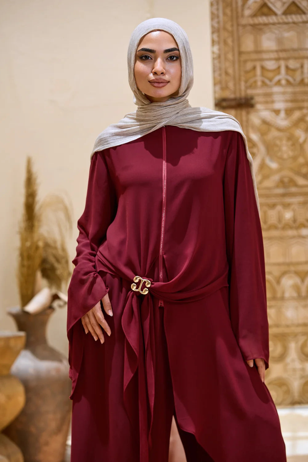Front detail of the burgundy layered chiffon tunic with wide sleeves and triangle-pointed panels
