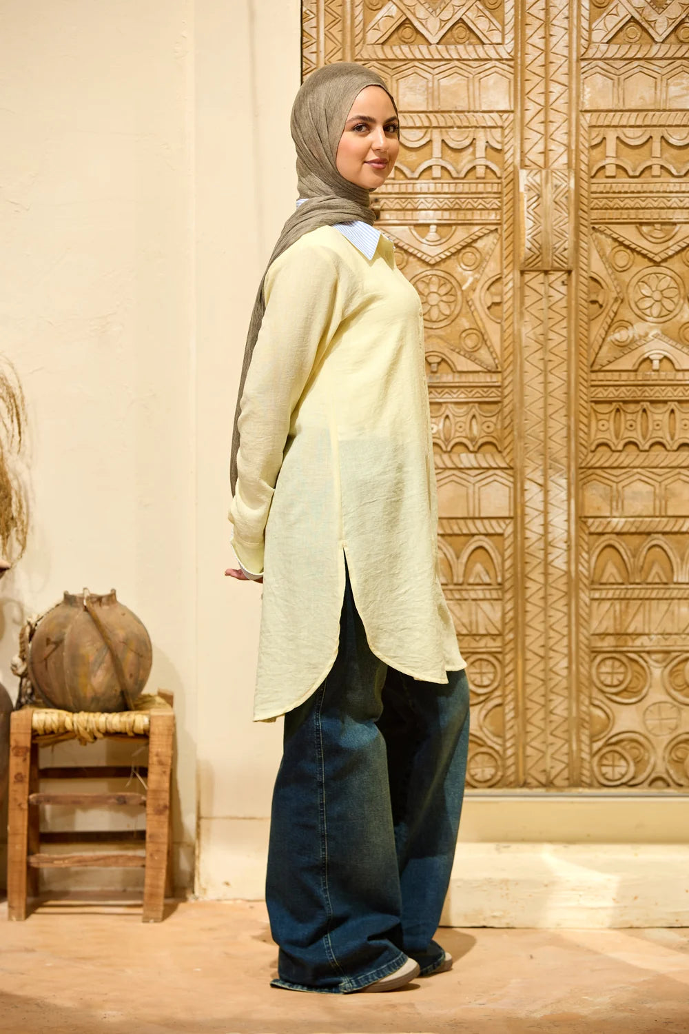 Full-length three-quarter view of the baby yellow Linen Shirt with Striped Details