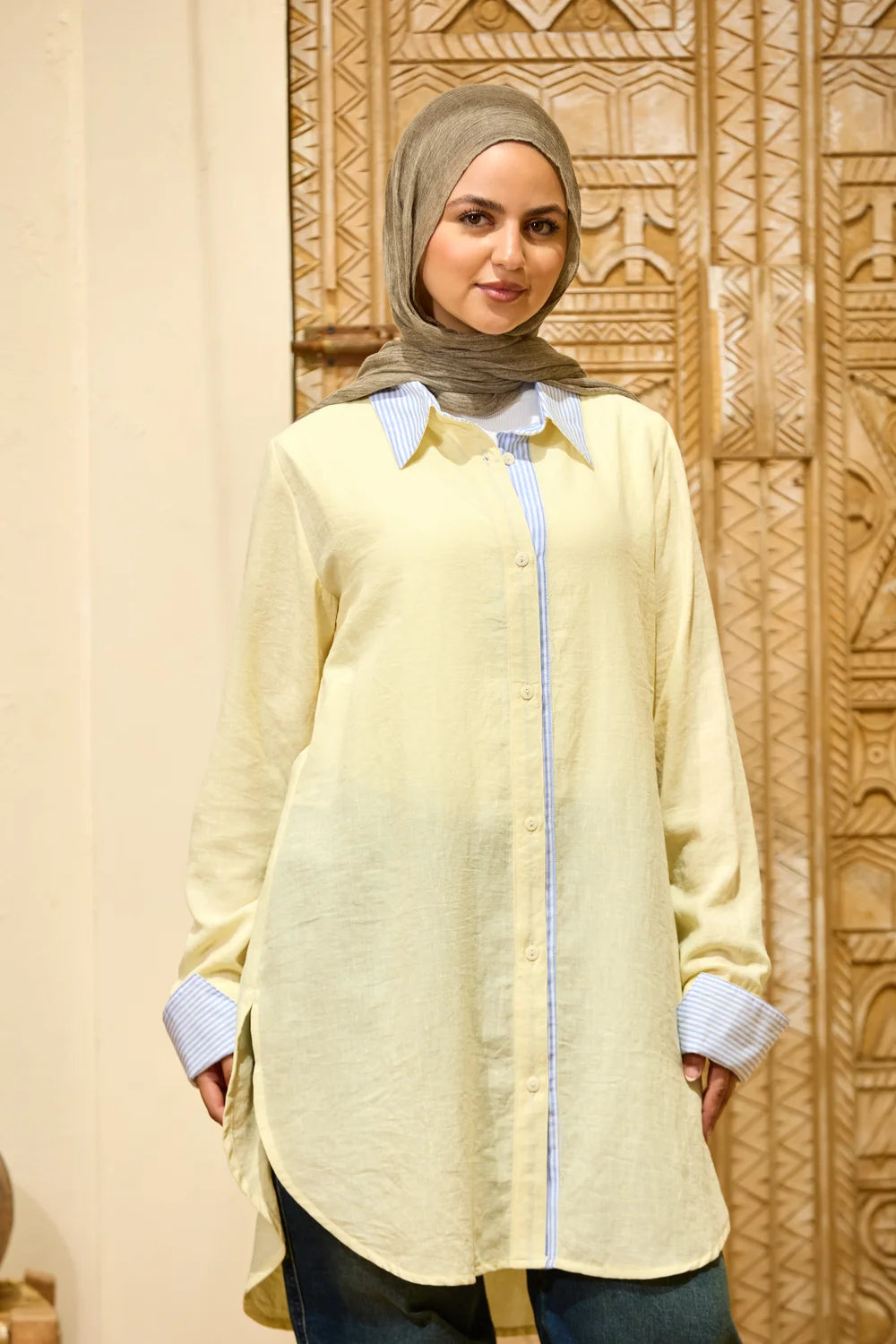 Front view of the baby yellow Linen Shirt with Striped Details and a relaxed curved hem