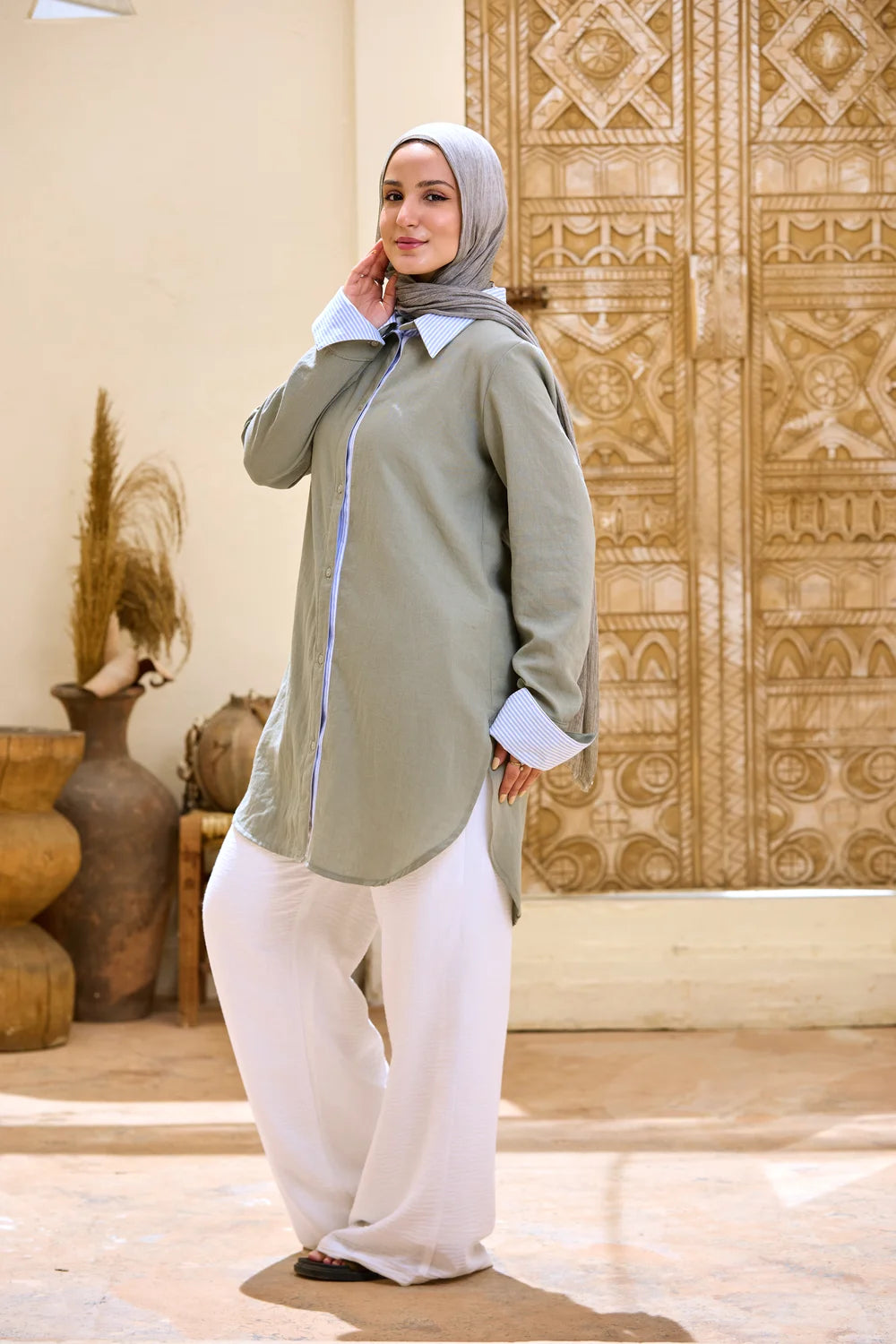 Full-length front view of the army green Linen Shirt with white wide-leg trousers