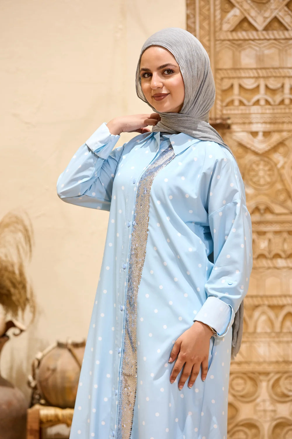 Baby blue polka dot maxi shirt dress showing the sequin front panel and long sleeves, three-quarter view