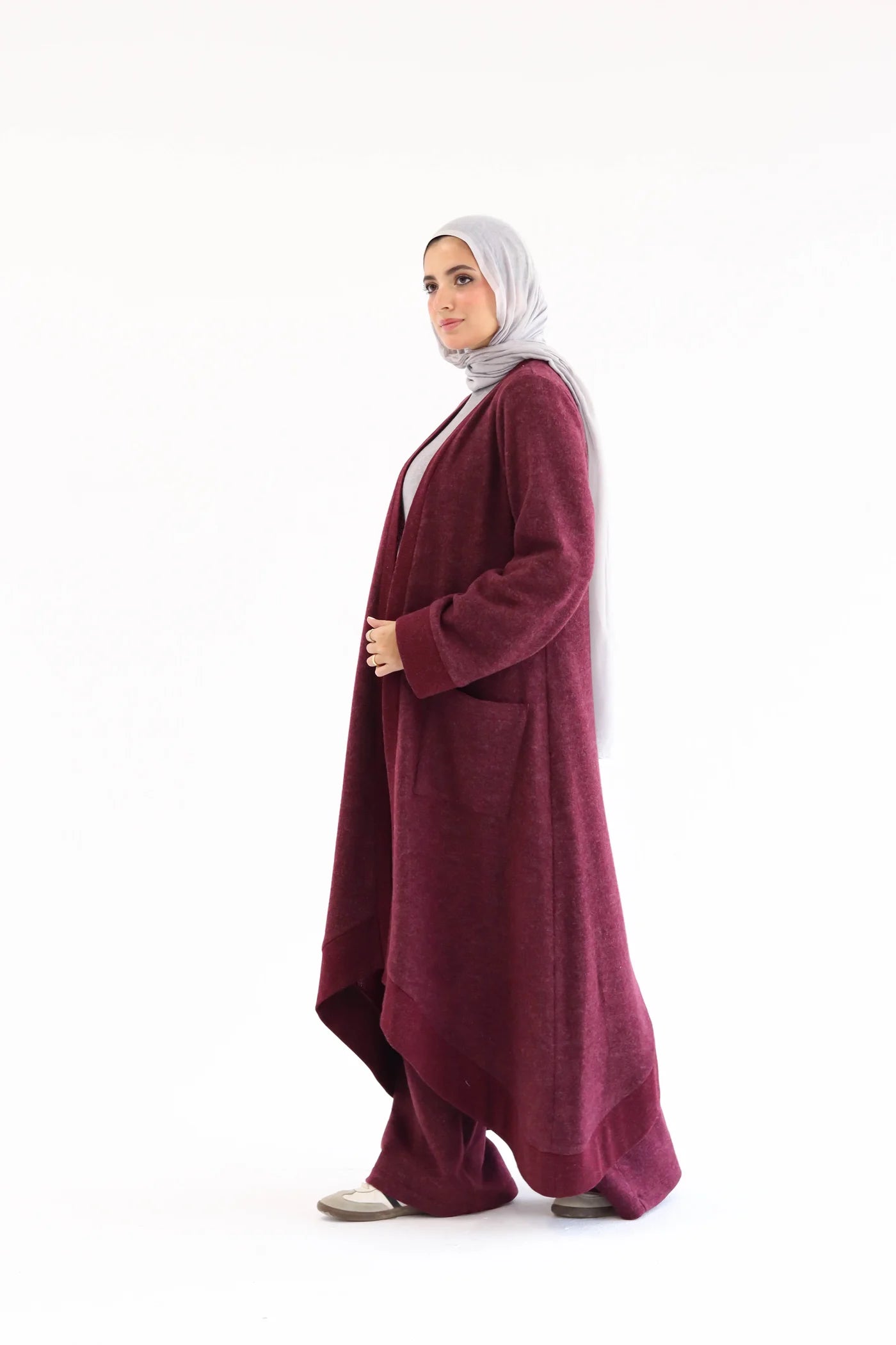 Burgundy cardigan set with flowing open-front cardigan and wide pants, side view showing length and movement.