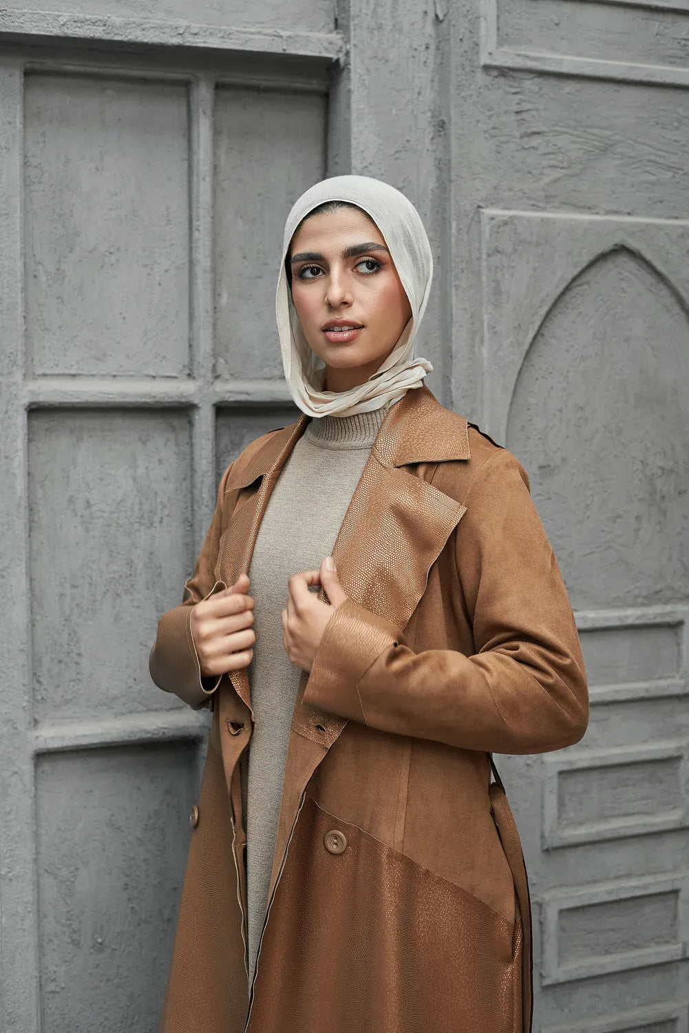 Women’s modest stylish caramel-beige trench coat – snake print leather and suede – side view on model