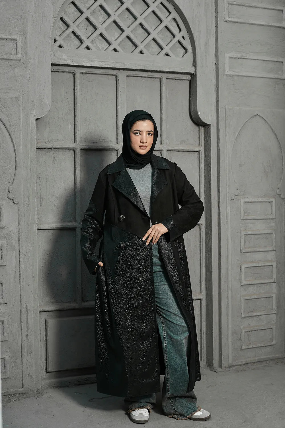 Women’s modest stylish black trench coat – snake print leather and suede – full length front view on model.”