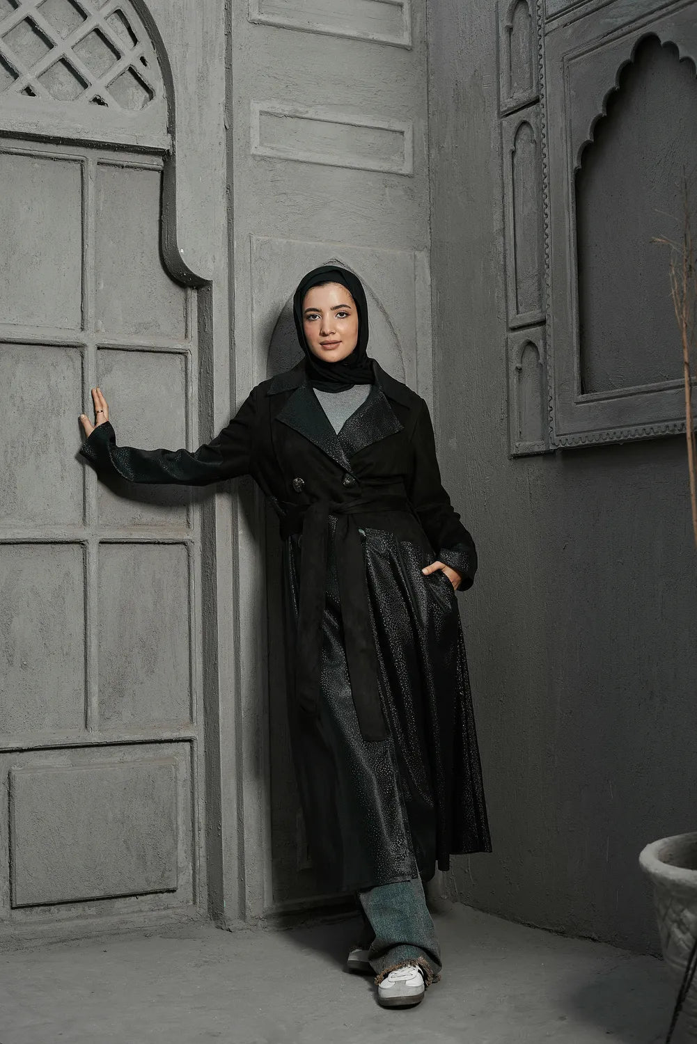 Women’s modest stylish black trench coat – snake print leather and suede – full length front view on model.”