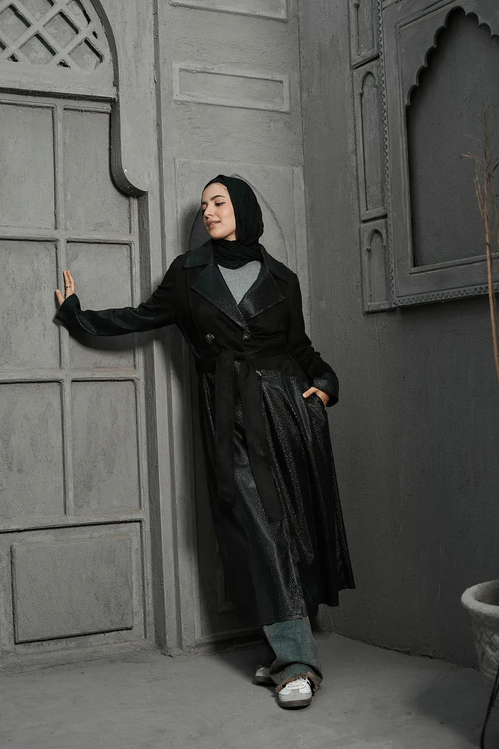 Women’s modest stylish black trench coat – snake print leather and suede – full length front view on model.”