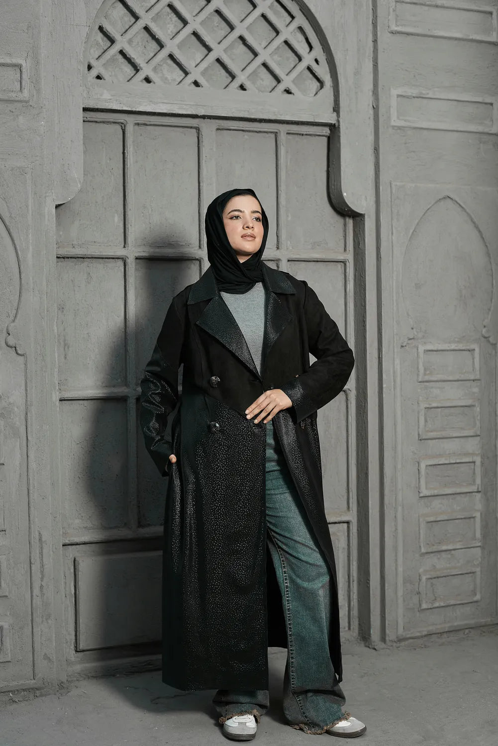 Women’s modest stylish black trench coat – snake print leather and suede – full length front view on model.”