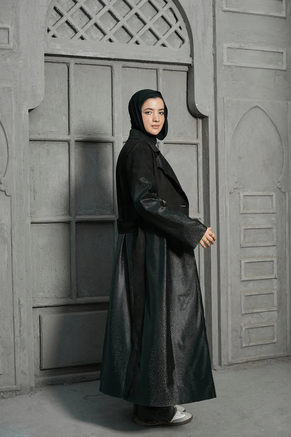 Women’s modest stylish black trench coat – snake print leather and suede – full length front view on model.”