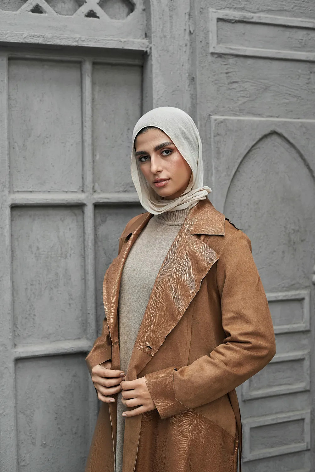 Women’s modest stylish caramel-beige trench coat – snake print leather and suede – side view on model